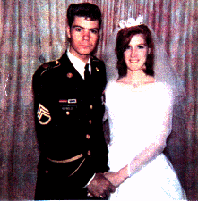 [Photo of Joe & Julie Reynolds at their wedding]